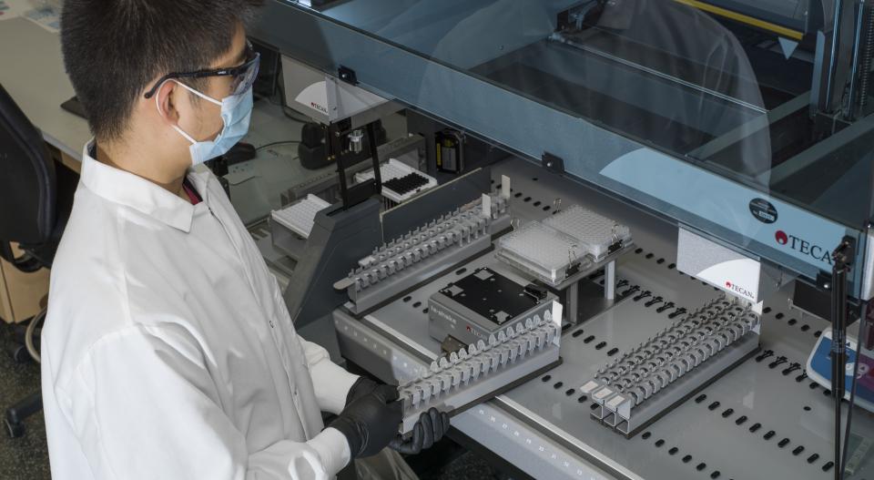 lab tech looking at mechanical equipment